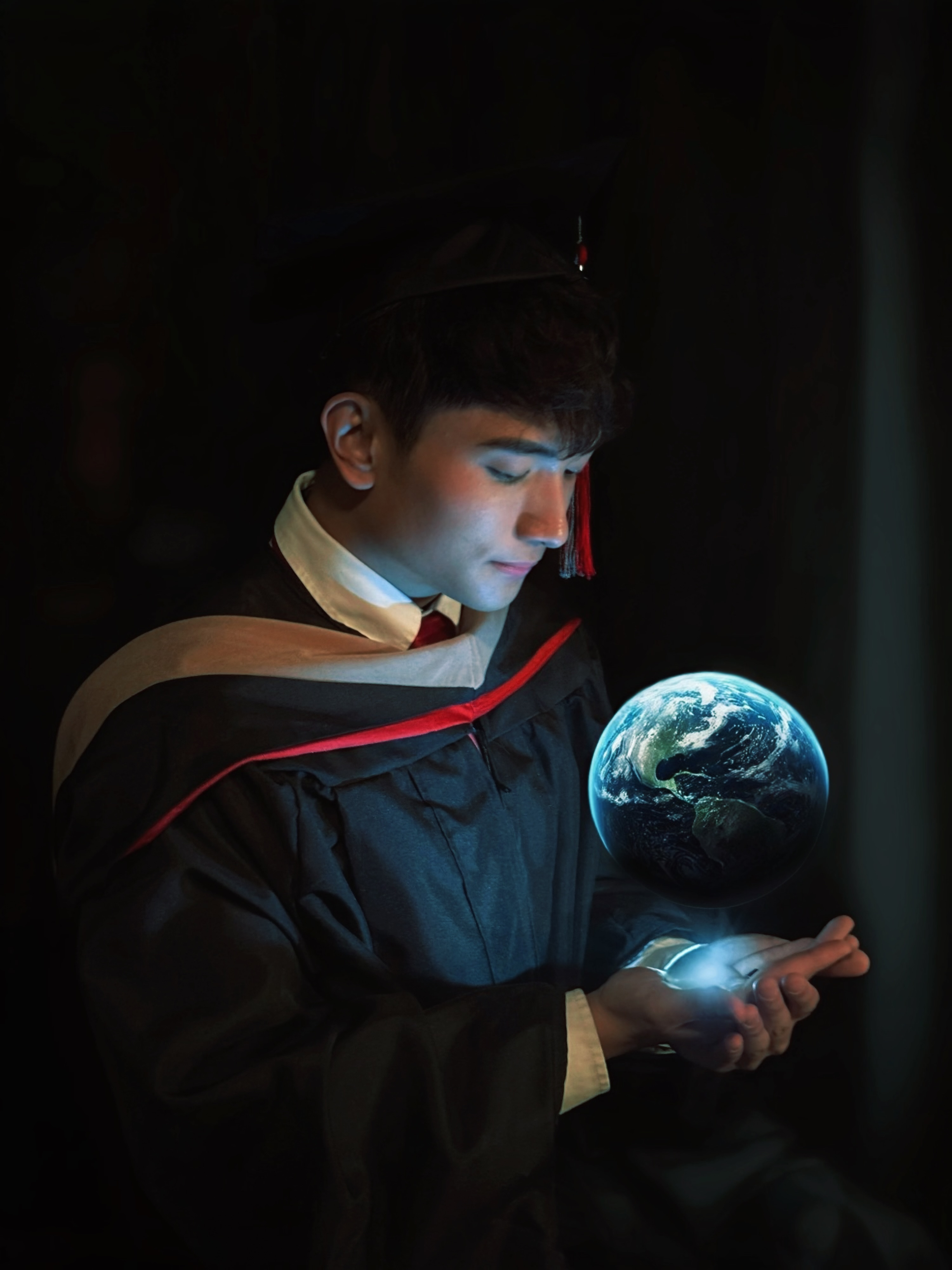 Commencement portrait of Mark Jayson Farol in evening light.