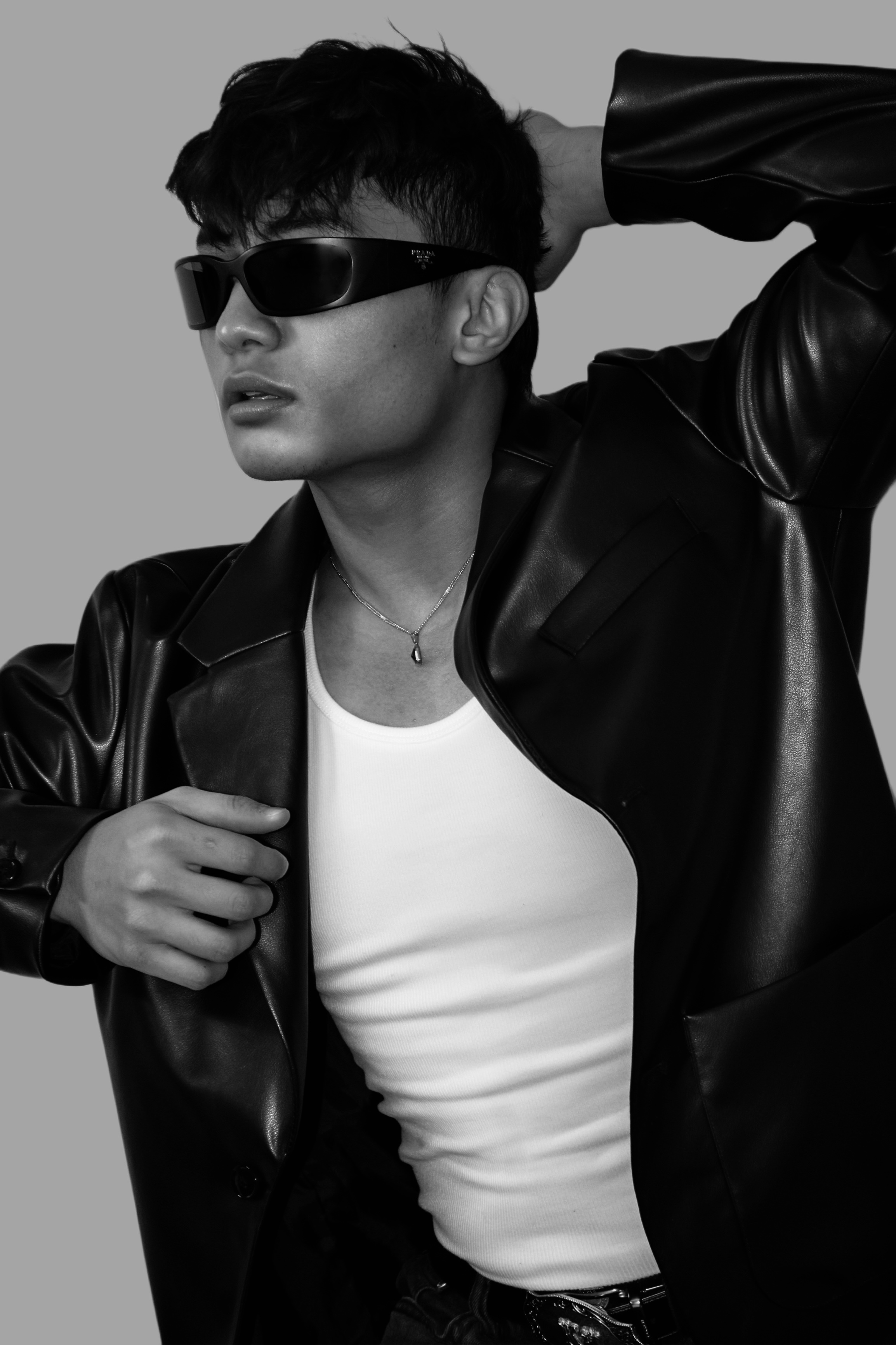 Black-and-white editorial portrait of Mark Jayson Farol in sunglasses and a leather jacket.